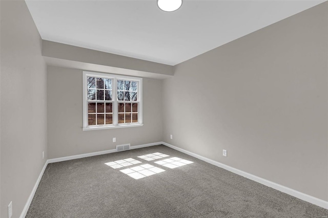 unfurnished room featuring visible vents, baseboards, and carpet