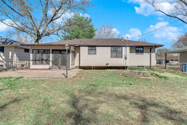 rear view of house with fence, a yard, roof with shingles, a sunroom, and crawl space