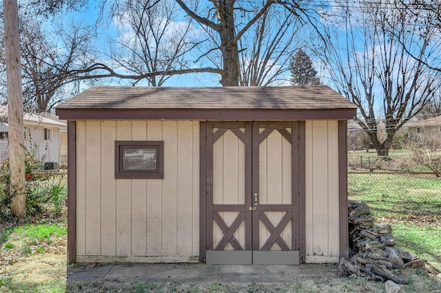 view of shed with fence