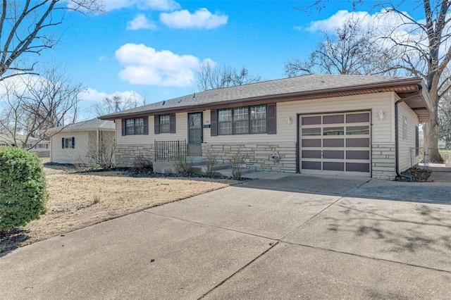 ranch-style house with stone siding, an attached garage, and driveway