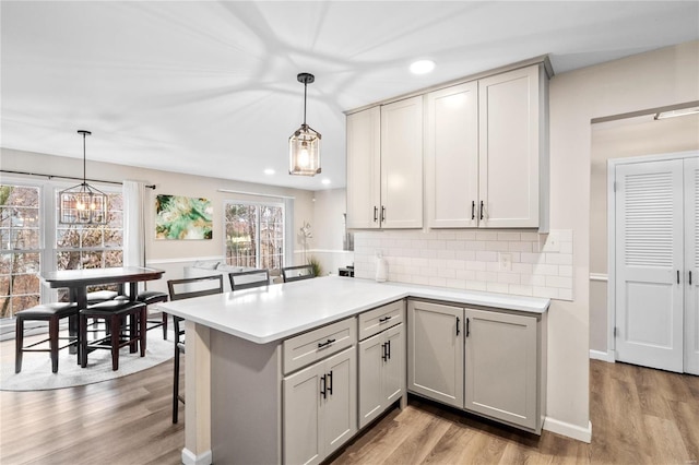 kitchen featuring light wood finished floors and light countertops