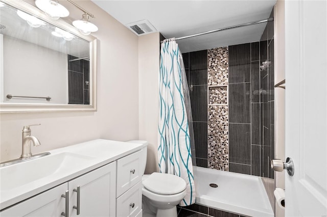 bathroom with vanity, toilet, visible vents, and a stall shower