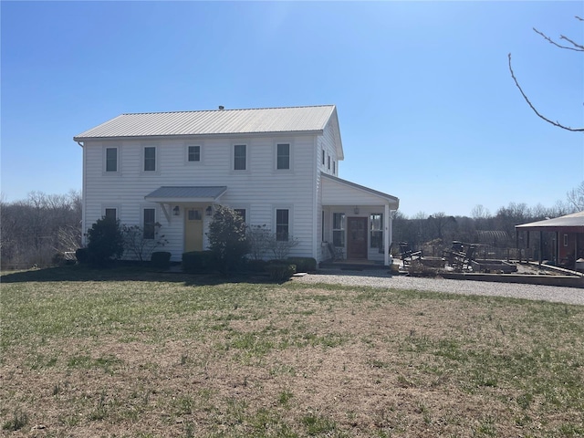 view of front of home with metal roof and a front yard