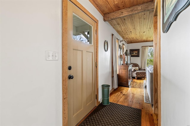 interior space featuring wood-type flooring, wood ceiling, and beamed ceiling