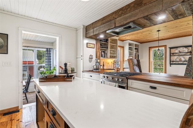 kitchen with visible vents, light wood finished floors, butcher block counters, stainless steel range with gas cooktop, and wood ceiling