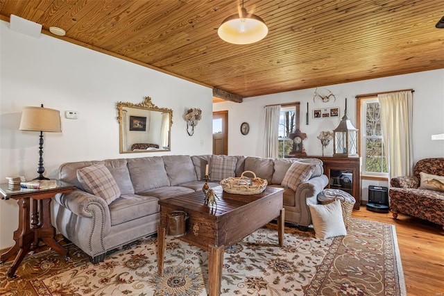 living area featuring wood ceiling and wood finished floors