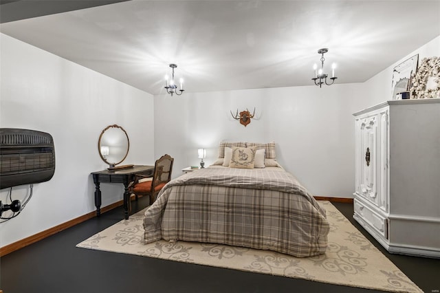 bedroom featuring baseboards and an inviting chandelier