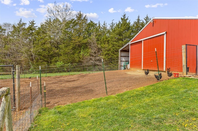 view of yard with an outdoor structure, an outbuilding, and fence