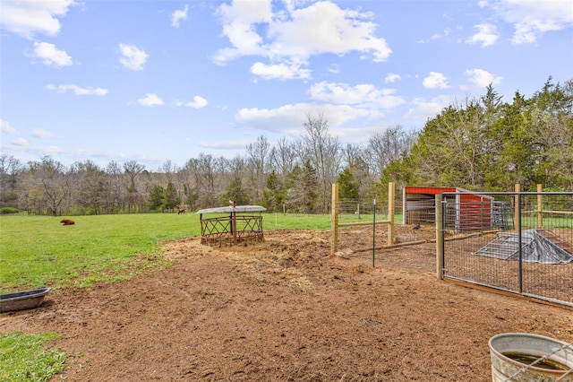 view of jungle gym featuring an outbuilding and a forest view