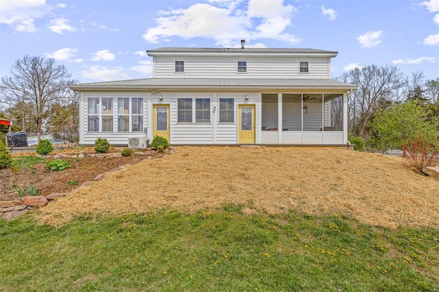 back of property featuring metal roof, a sunroom, ac unit, and a yard