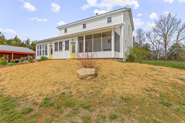 back of house featuring a sunroom