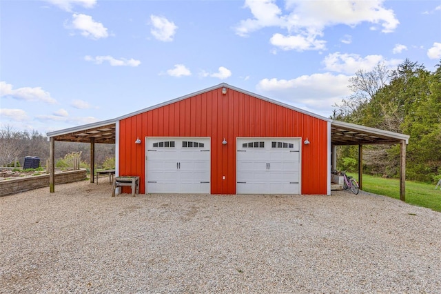 garage featuring driveway and a detached garage