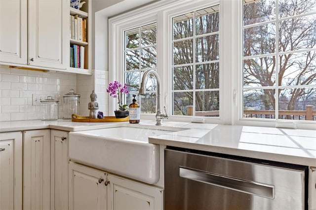 kitchen featuring a sink, stainless steel dishwasher, decorative backsplash, and open shelves