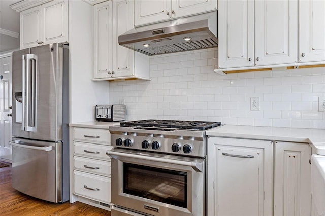 kitchen featuring light countertops, white cabinets, under cabinet range hood, and stainless steel appliances