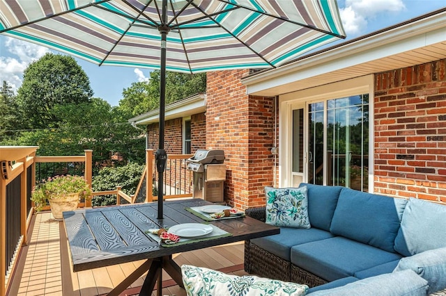 wooden terrace with an outdoor living space and grilling area