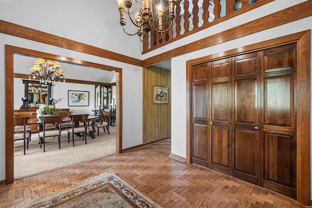 entrance foyer with baseboards, a towering ceiling, and an inviting chandelier