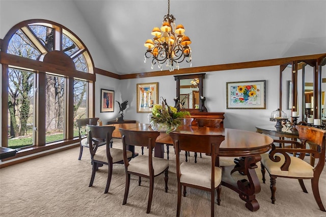 dining room featuring an inviting chandelier, carpet floors, and high vaulted ceiling