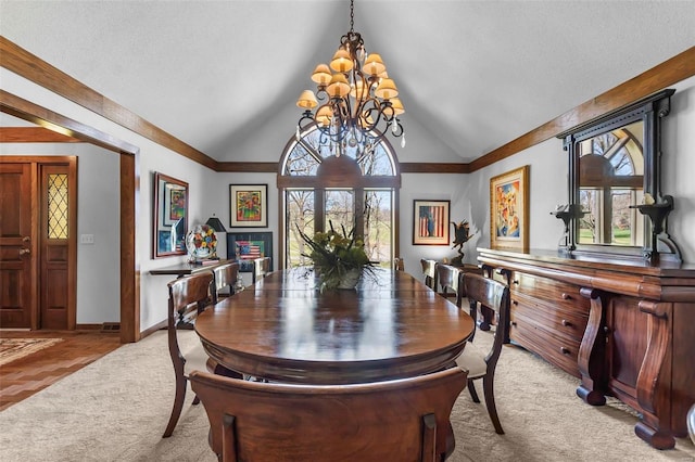 dining room featuring a chandelier, light carpet, a textured ceiling, lofted ceiling, and baseboards