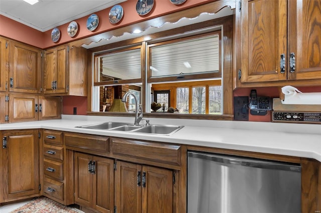 kitchen featuring stainless steel dishwasher, brown cabinets, and a sink