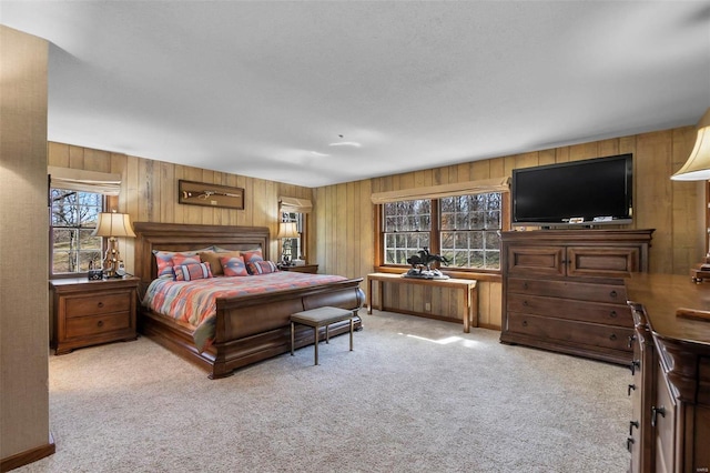 bedroom with wood walls and carpet floors