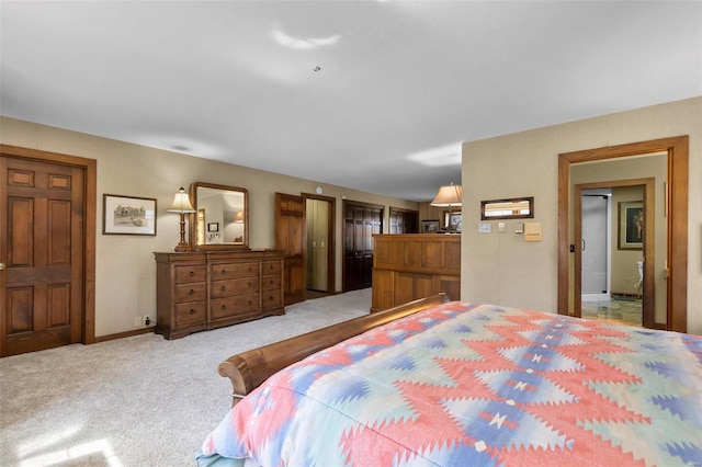 bedroom with baseboards and light colored carpet