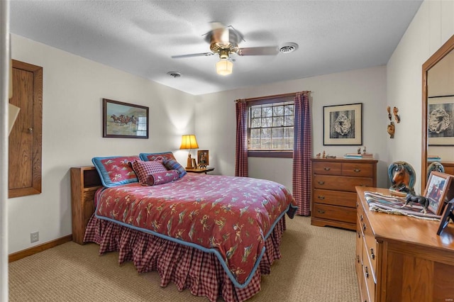 bedroom with light carpet, visible vents, and a textured ceiling