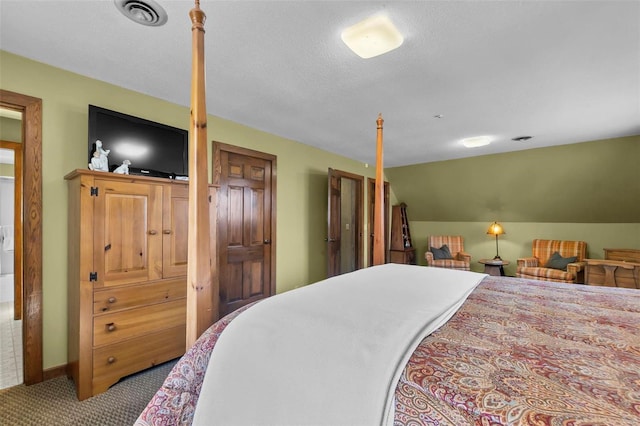 carpeted bedroom featuring lofted ceiling, a textured ceiling, and visible vents