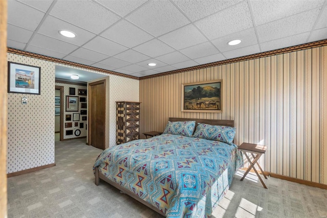 carpeted bedroom with baseboards, wallpapered walls, a drop ceiling, and recessed lighting