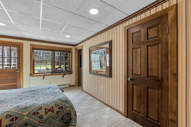 bedroom with a baseboard radiator, wallpapered walls, light carpet, and recessed lighting
