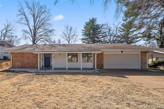 ranch-style home with a garage and driveway