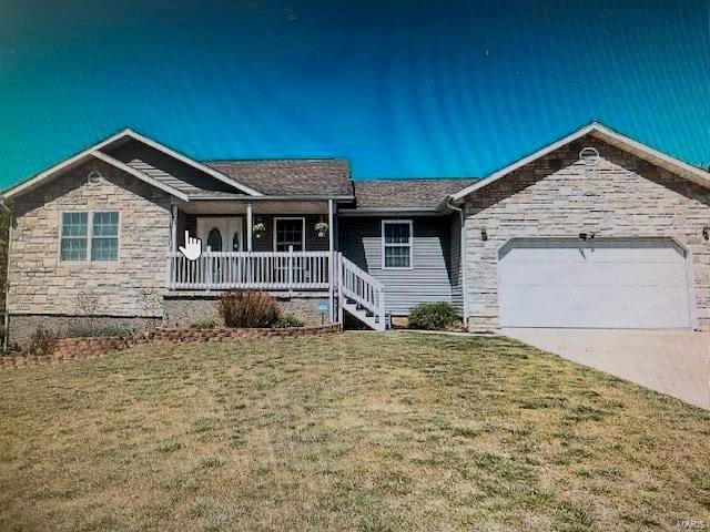 ranch-style home with a front lawn, covered porch, a garage, stone siding, and driveway