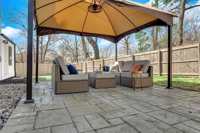 view of patio featuring outdoor lounge area, a gazebo, and a fenced backyard