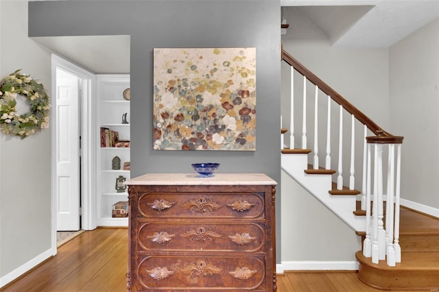 interior space featuring baseboards and wood finished floors