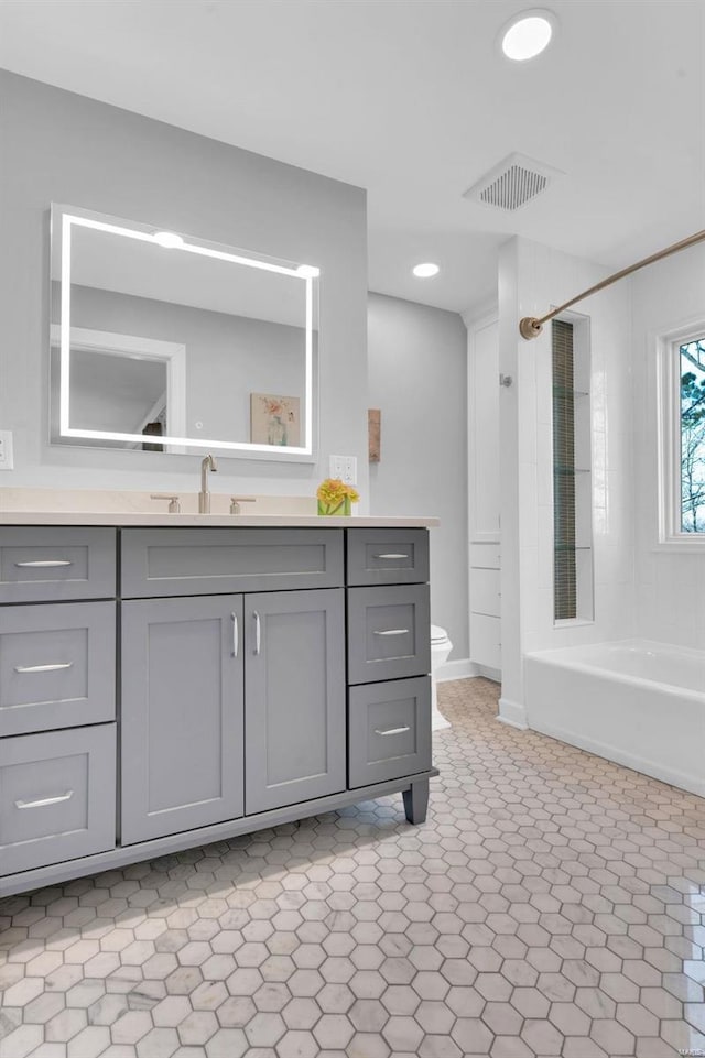 full bath featuring visible vents, toilet, recessed lighting, shower / bathtub combination, and vanity