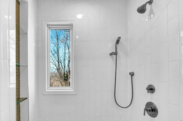 interior details featuring a tile shower