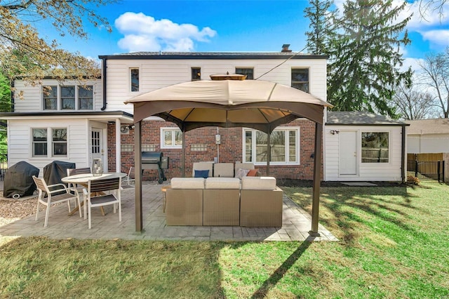 back of house with a patio, fence, a lawn, brick siding, and an outdoor hangout area