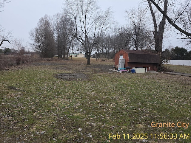 view of yard with a storage unit, an outdoor structure, and fence