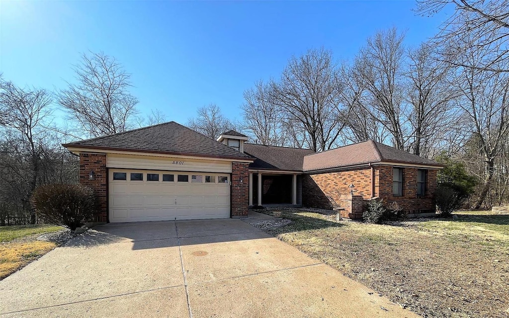 ranch-style home with brick siding, driveway, a garage, and roof with shingles