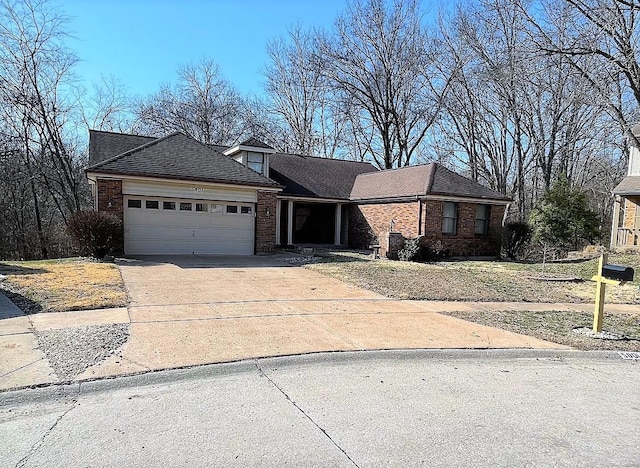 ranch-style house featuring concrete driveway, brick siding, a garage, and roof with shingles