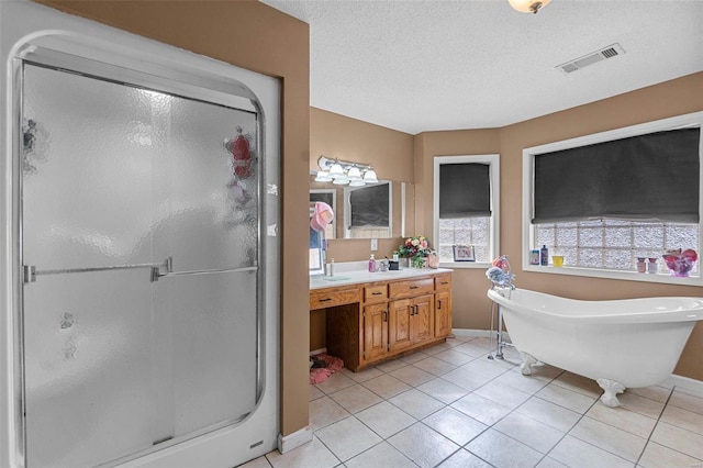 full bath featuring visible vents, a shower stall, tile patterned flooring, a soaking tub, and vanity