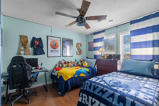 bedroom with ceiling fan, baseboards, a textured ceiling, and wood finished floors