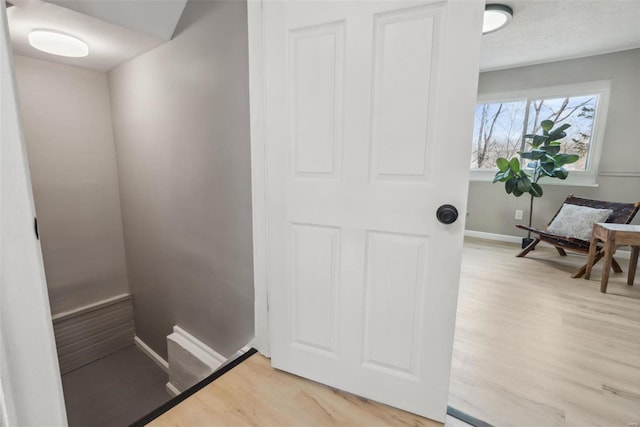 interior space featuring wood finished floors and baseboards