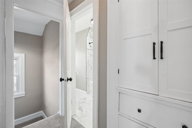 bathroom featuring marble finish floor and baseboards