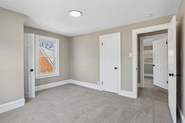 unfurnished bedroom with baseboards and carpet floors