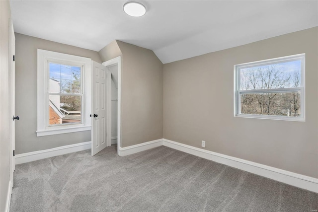 bonus room featuring lofted ceiling, baseboards, and carpet floors