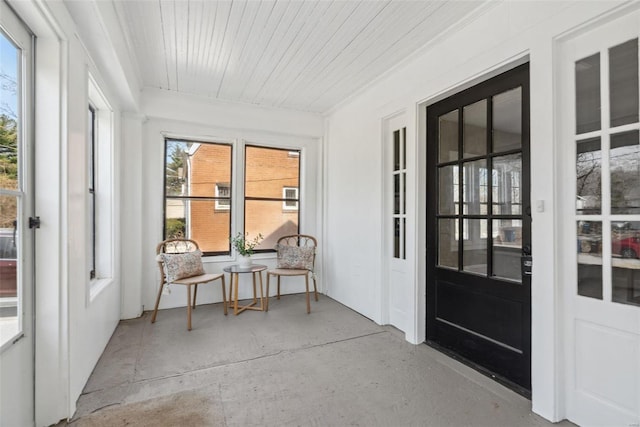 sunroom / solarium featuring wooden ceiling and plenty of natural light