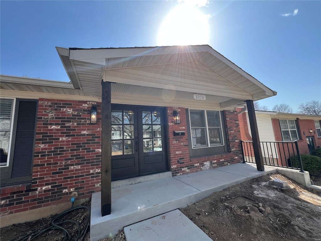 entrance to property with french doors and brick siding