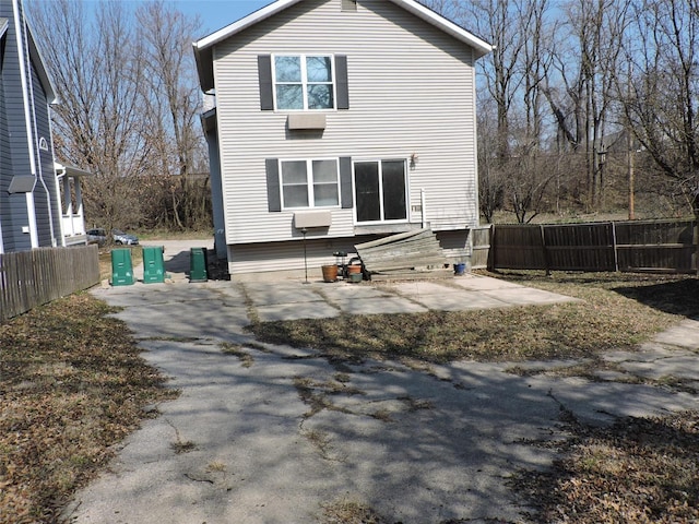 rear view of property featuring fence