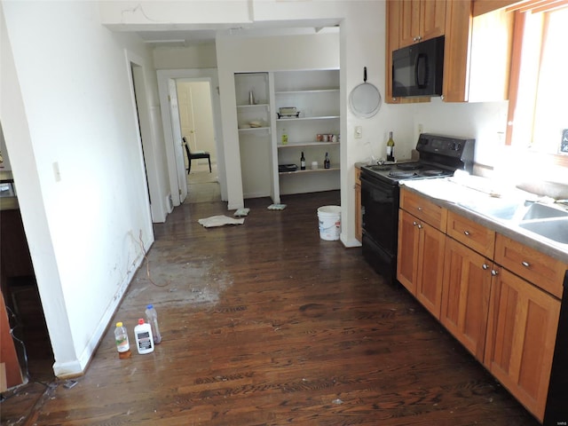 kitchen featuring baseboards, light countertops, brown cabinetry, black appliances, and dark wood-style flooring