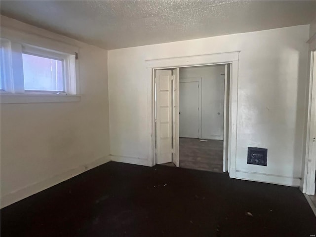 unfurnished bedroom featuring a closet and a textured ceiling